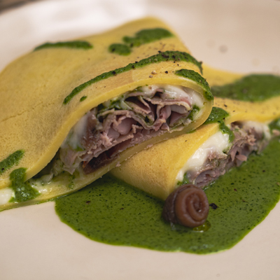Savoury crêpe with Stracchino cheese, Delicius anchovies in olive oil, arugula and Prague ham